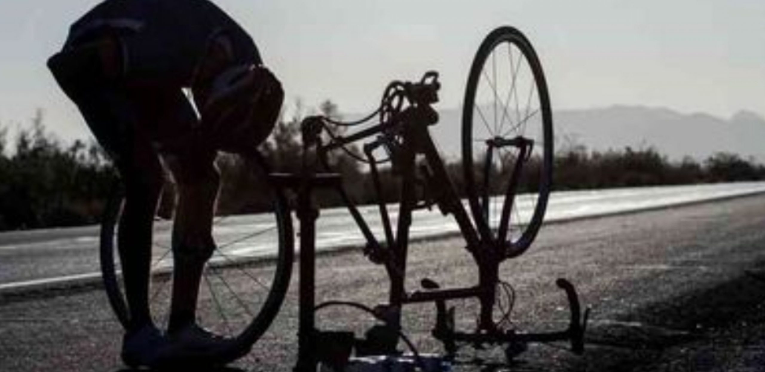 Anthony Crilly changing a flat tire on his bike